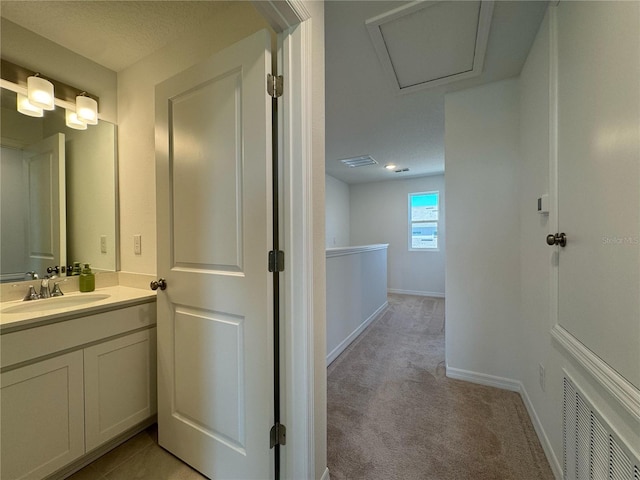 bathroom with visible vents, baseboards, and vanity
