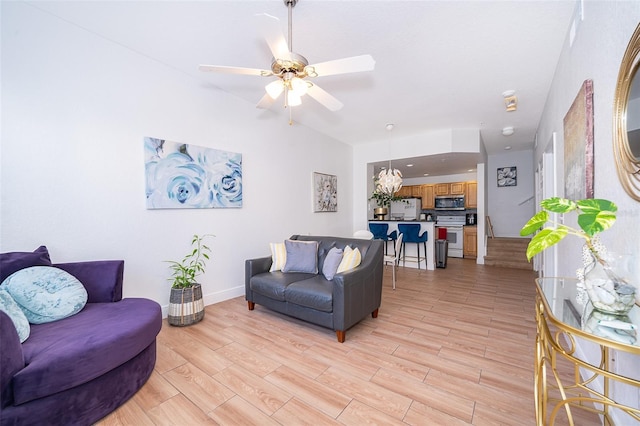 4011 Venetian Bay Dr Unit 103, Kissimmee, FL 34741 - living area featuring baseboards, light wood finished floors, and a ceiling fan