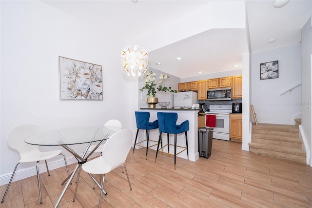 4011 Venetian Bay Dr Unit 103, Kissimmee, FL 34741 - dining area featuring a notable chandelier, baseboards, recessed lighting, stairway, and light wood finished floors