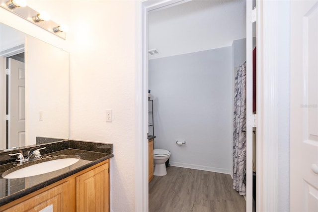 4011 Venetian Bay Dr Unit 103, Kissimmee, FL 34741 - bathroom featuring vanity, baseboards, toilet, visible vents, and wood finished floors