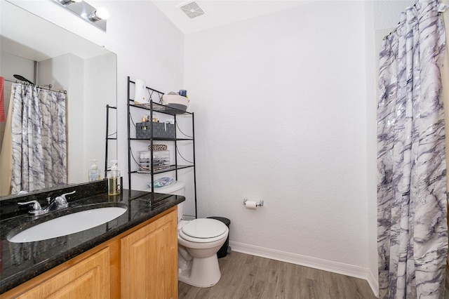4011 Venetian Bay Dr Unit 103, Kissimmee, FL 34741 - bathroom with vanity, baseboards, toilet, visible vents, and wood finished floors