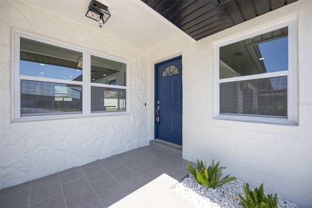entrance to property featuring stucco siding