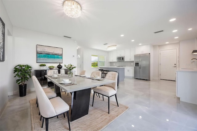 dining space with a chandelier, visible vents, and recessed lighting
