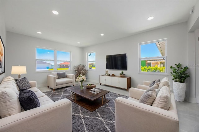 living area featuring baseboards and recessed lighting