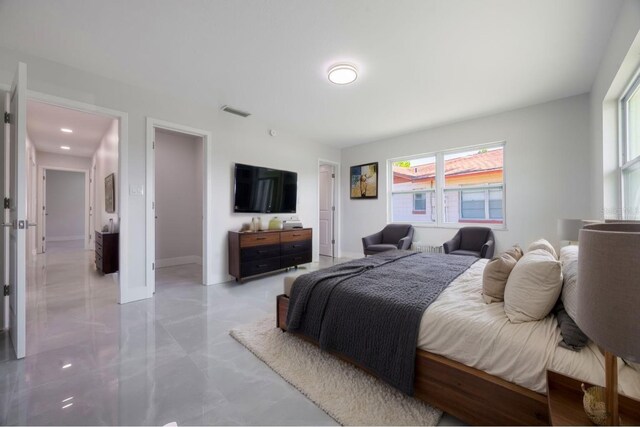 bedroom with visible vents and multiple windows
