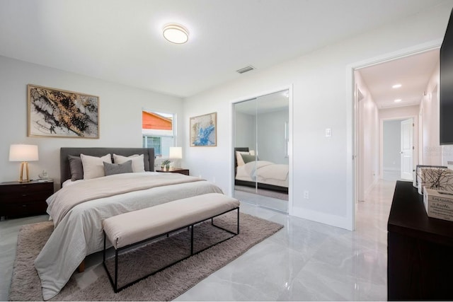 bedroom featuring visible vents, marble finish floor, and a closet