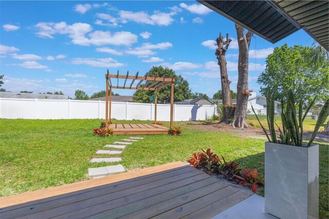 view of yard featuring a wooden deck, a fenced backyard, and a pergola