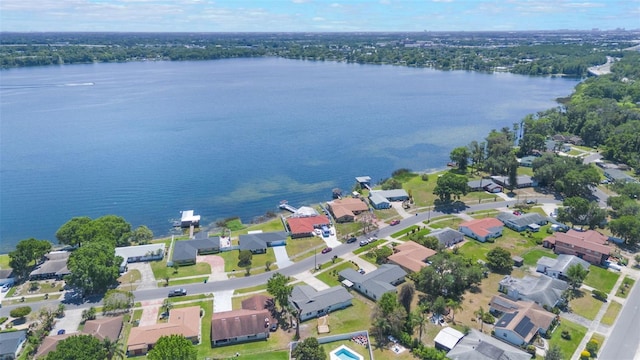 drone / aerial view featuring a water view and a residential view