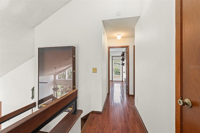 hallway featuring a textured ceiling and wood-type flooring