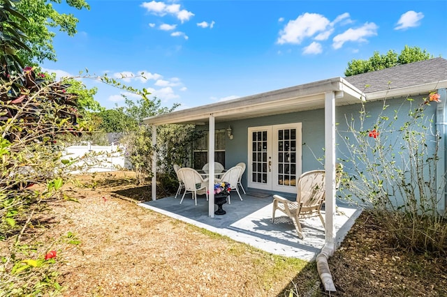 rear view of property featuring fence private yard, a patio area, stucco siding, and french doors