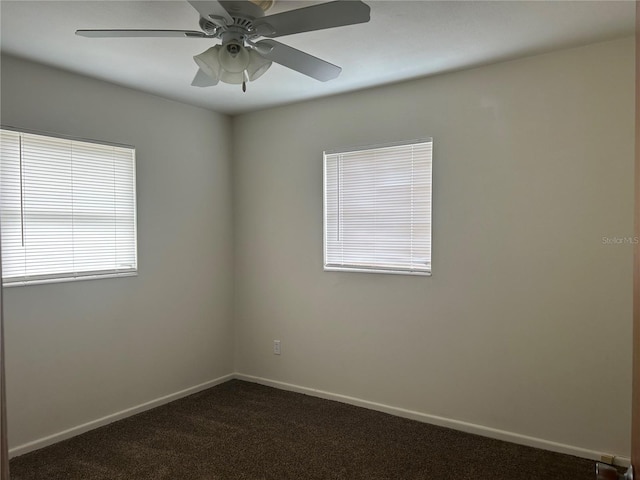 unfurnished room featuring ceiling fan, baseboards, and dark colored carpet