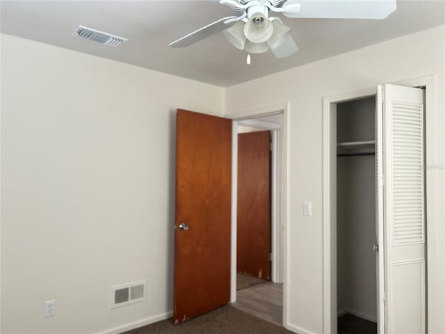 unfurnished bedroom with a closet, carpet, visible vents, and baseboards