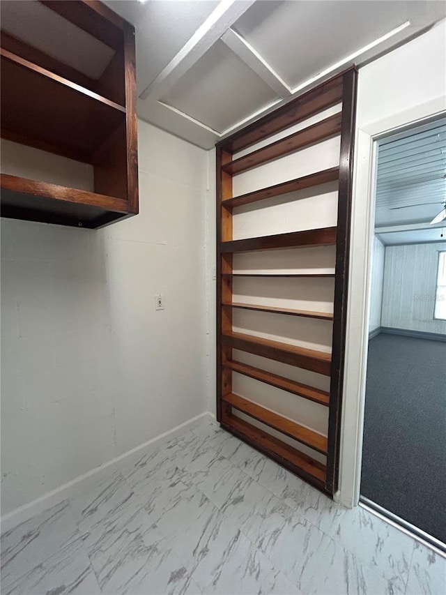 spacious closet featuring marble finish floor