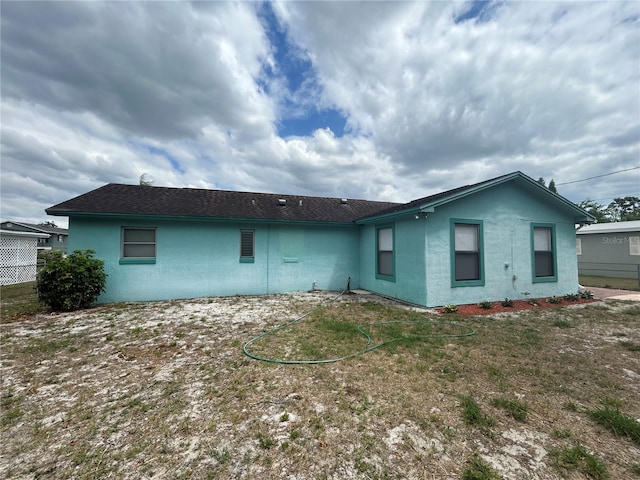 rear view of property with stucco siding