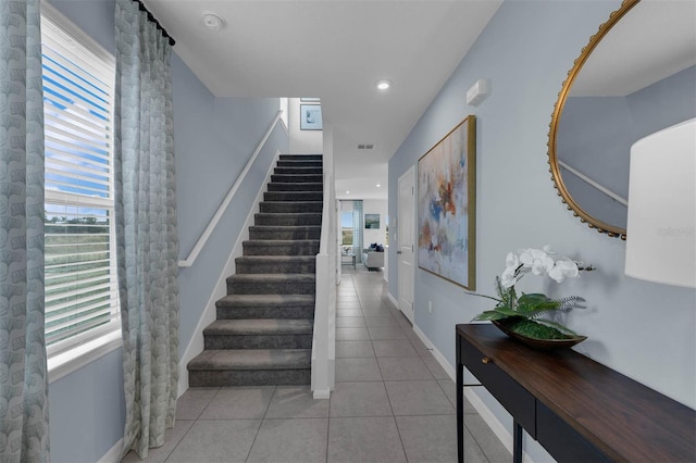 1409 Fan Palm Dr, Davenport, FL 33897 - stairs with tile patterned floors, recessed lighting, baseboards, and a wealth of natural light