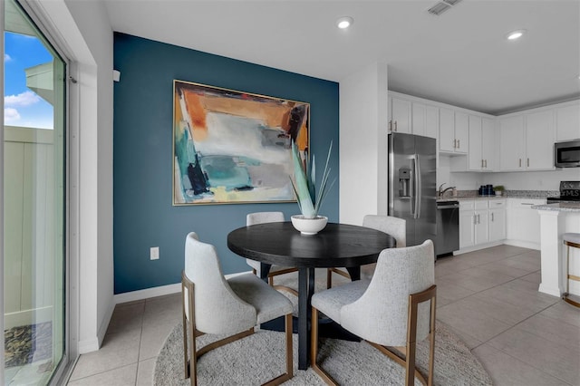 1409 Fan Palm Dr, Davenport, FL 33897 - dining area with recessed lighting, light tile patterned floors, visible vents, and baseboards