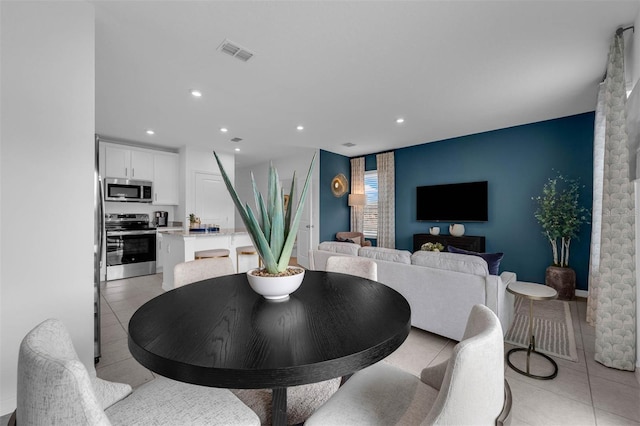 1409 Fan Palm Dr, Davenport, FL 33897 - dining area featuring light tile patterned floors, visible vents, and recessed lighting
