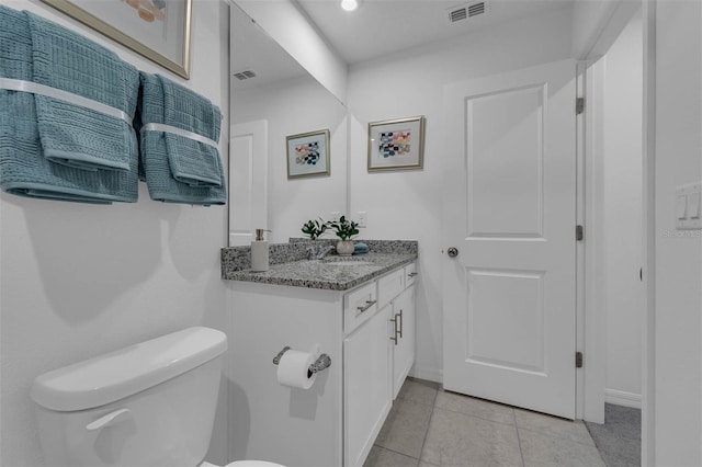 1409 Fan Palm Dr, Davenport, FL 33897 - half bath with vanity, visible vents, toilet, tile patterned floors, and baseboards