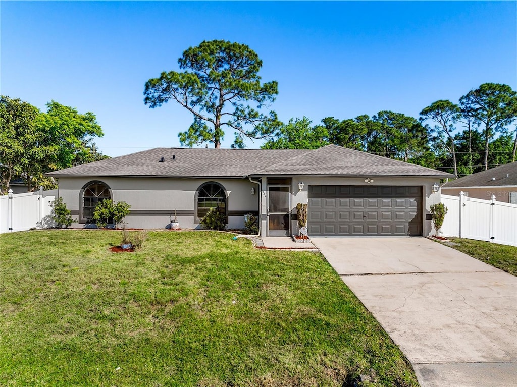 single story home featuring stucco siding, an attached garage, fence, and concrete driveway