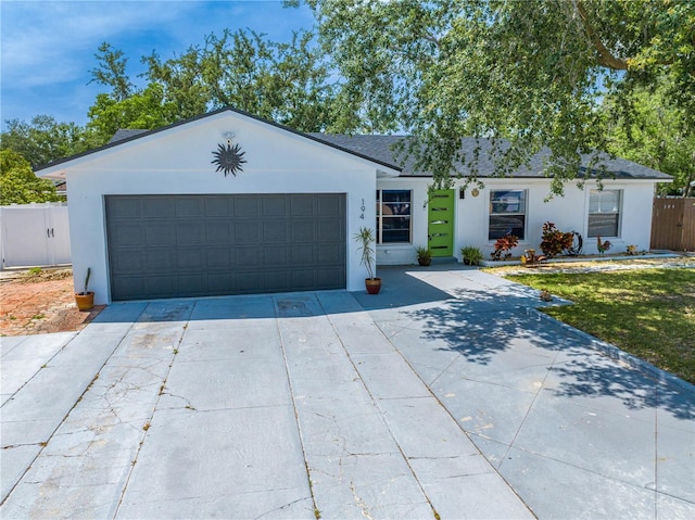 194 Larkspur Ct, Kissimmee, FL 34743 - single story home with stucco siding, an attached garage, driveway, and fence