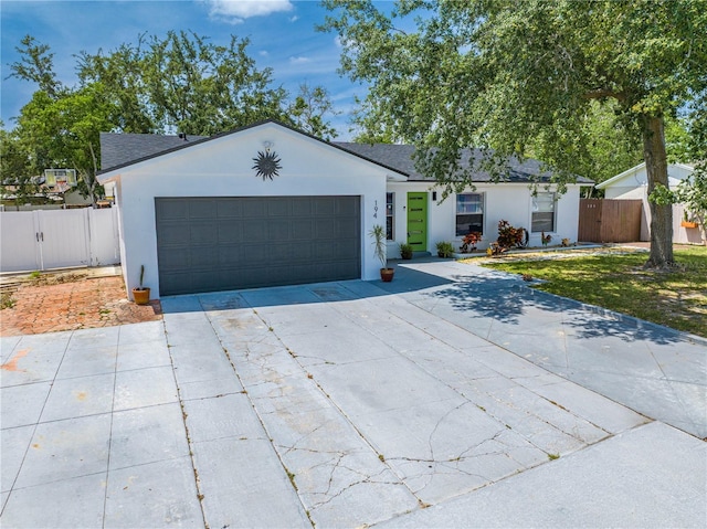 194 Larkspur Ct, Kissimmee, FL 34743 - ranch-style house featuring an attached garage, driveway, fence, and stucco siding