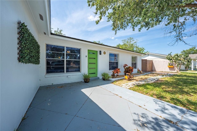 194 Larkspur Ct, Kissimmee, FL 34743 - view of front of home with a patio area, stucco siding, and fence