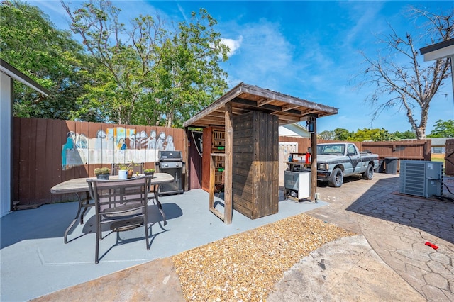194 Larkspur Ct, Kissimmee, FL 34743 - view of patio / terrace with central AC, outdoor dining space, a fenced backyard, and area for grilling