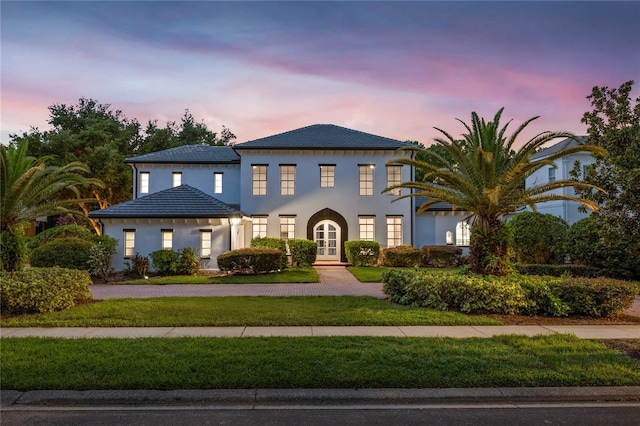 10849 Emerald Chase Dr, Orlando, FL 32836 - view of front of property featuring french doors, a lawn, curved driveway, and stucco siding