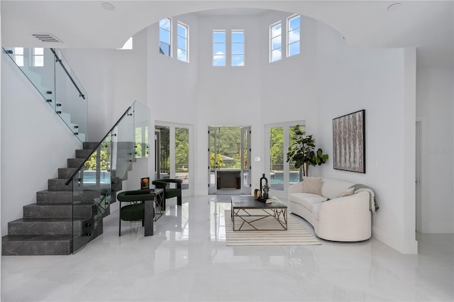 10849 Emerald Chase Dr, Orlando, FL 32836 - living room featuring stairway, a high ceiling, arched walkways, and marble tiled floors