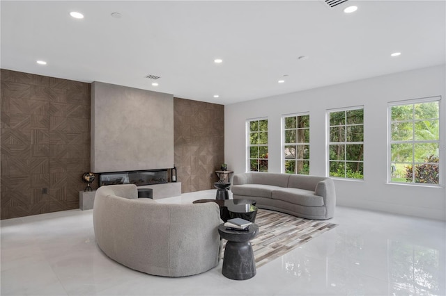 10849 Emerald Chase Dr, Orlando, FL 32836 - living room with recessed lighting, a glass covered fireplace, and tile walls