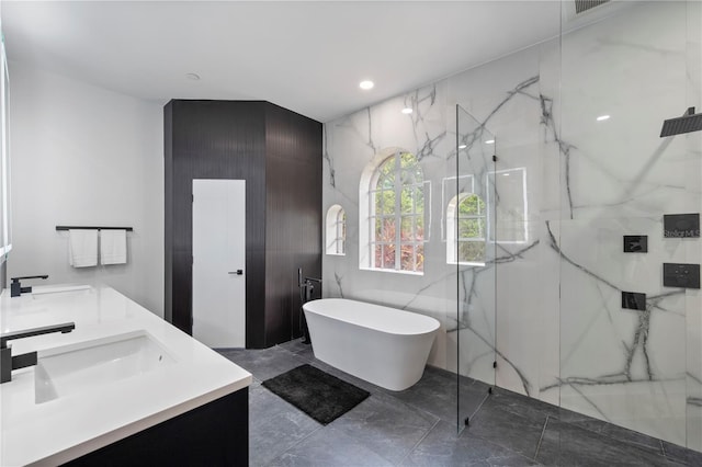 10849 Emerald Chase Dr, Orlando, FL 32836 - bathroom with a marble finish shower, marble tiled floors, double vanity, a freestanding bath, and recessed lighting