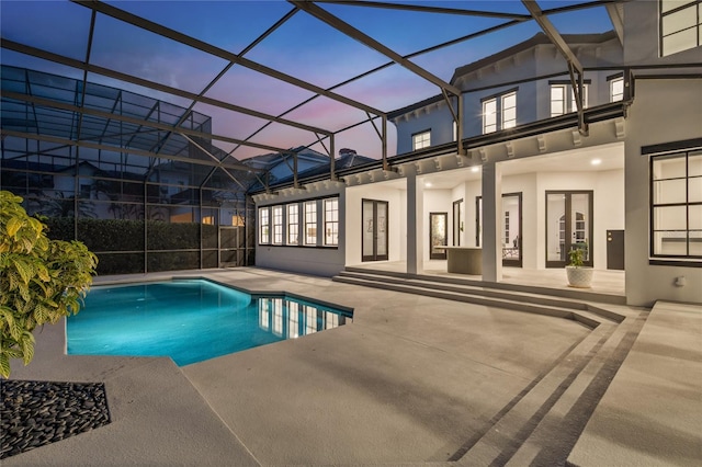 10849 Emerald Chase Dr, Orlando, FL 32836 - pool at dusk featuring a patio and a lanai