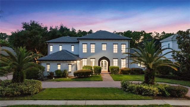 10849 Emerald Chase Dr, Orlando, FL 32836 - view of front of house featuring french doors, a lawn, and stucco siding