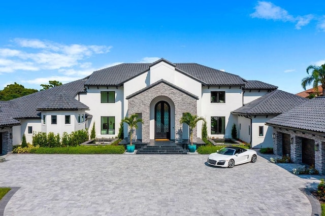 570 Manor Rd, Maitland, FL 32751 - french country home featuring stucco siding, stone siding, and a tiled roof