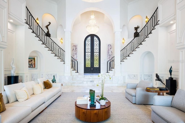 570 Manor Rd, Maitland, FL 32751 - living room featuring a towering ceiling, arched walkways, and a decorative wall