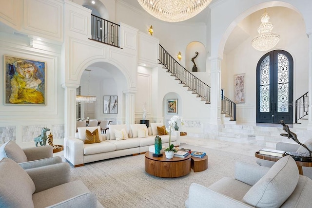 570 Manor Rd, Maitland, FL 32751 - living area with a high ceiling, arched walkways, a notable chandelier, and a decorative wall