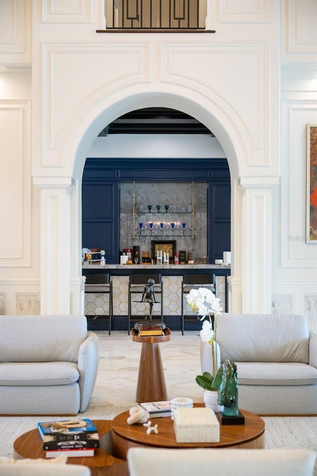 570 Manor Rd, Maitland, FL 32751 - living area featuring arched walkways, a decorative wall, and bar area
