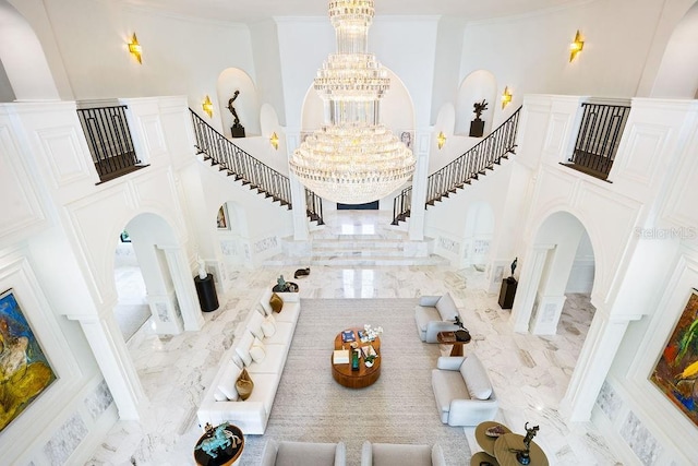 570 Manor Rd, Maitland, FL 32751 - entrance foyer with marble finish floor, stairs, a chandelier, and a towering ceiling