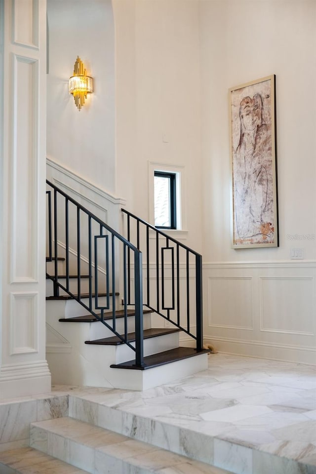 570 Manor Rd, Maitland, FL 32751 - stairs with wainscoting and a decorative wall