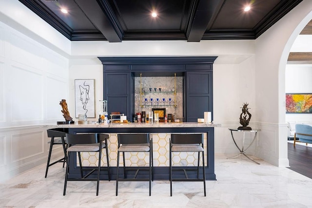 570 Manor Rd, Maitland, FL 32751 - bar with a decorative wall, crown molding, marble finish floor, arched walkways, and a dry bar