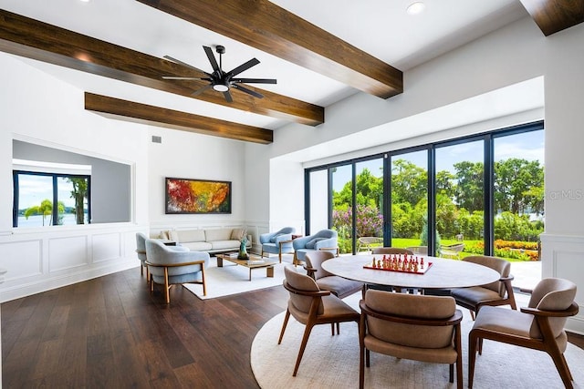 570 Manor Rd, Maitland, FL 32751 - dining room with dark wood-style flooring, wainscoting, beamed ceiling, ceiling fan, and a decorative wall