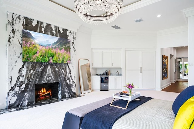 570 Manor Rd, Maitland, FL 32751 - bedroom featuring an inviting chandelier, a fireplace, ornamental molding, wine cooler, and visible vents