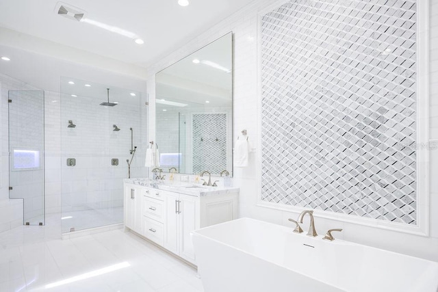 570 Manor Rd, Maitland, FL 32751 - bathroom featuring recessed lighting, a shower stall, a freestanding bath, visible vents, and a sink