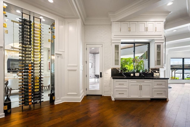 570 Manor Rd, Maitland, FL 32751 - wine area featuring brick wall, dark wood-type flooring, and ornamental molding