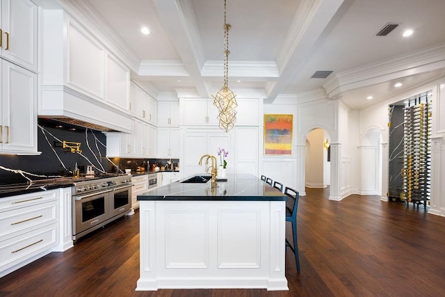 570 Manor Rd, Maitland, FL 32751 - kitchen featuring arched walkways, dark countertops, a sink, and visible vents