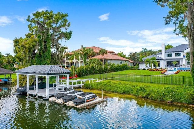570 Manor Rd, Maitland, FL 32751 - view of dock featuring fence, a yard, boat lift, and a water view