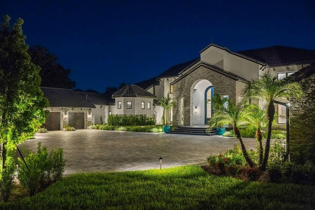 570 Manor Rd, Maitland, FL 32751 - french provincial home with stucco siding, decorative driveway, a tiled roof, and a garage