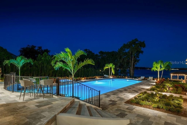 570 Manor Rd, Maitland, FL 32751 - pool at night with a community pool and a patio