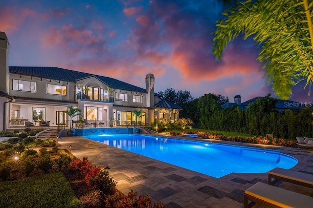 570 Manor Rd, Maitland, FL 32751 - pool at dusk featuring an outdoor pool and a patio