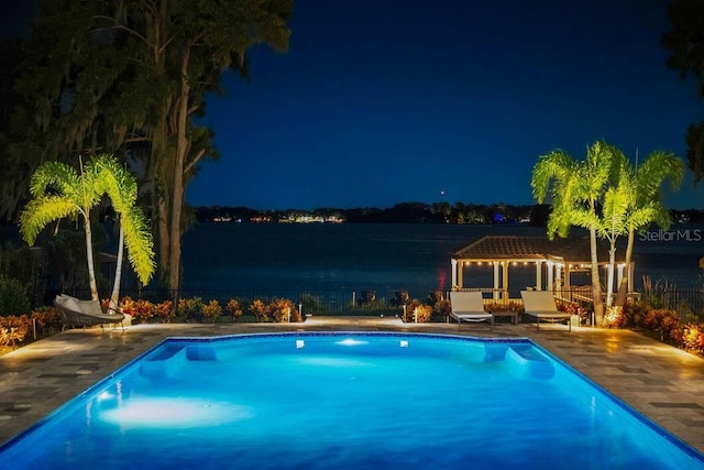 570 Manor Rd, Maitland, FL 32751 - pool at night with fence, a patio, and a fenced in pool